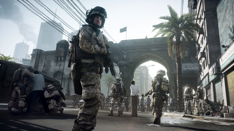 Soldats en patrouille sous un grand portail dans Battlefield 3 sur PC