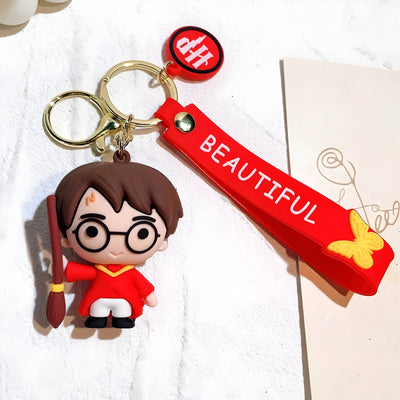 Porte-clés Harry Potter en silicone rouge avec figurine cartoon de Harry en robe rouge tenant sa baguette