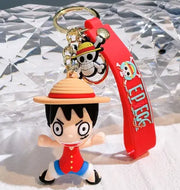 Porte-clés One Piece Luffy 08 : bracelet silicone rouge avec texte One Piece blanc et pendentif personnage cartoon