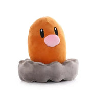 Peluche Pokémon Taupiqueur orange aux yeux noirs et nez rose sur base grise, 15 cm