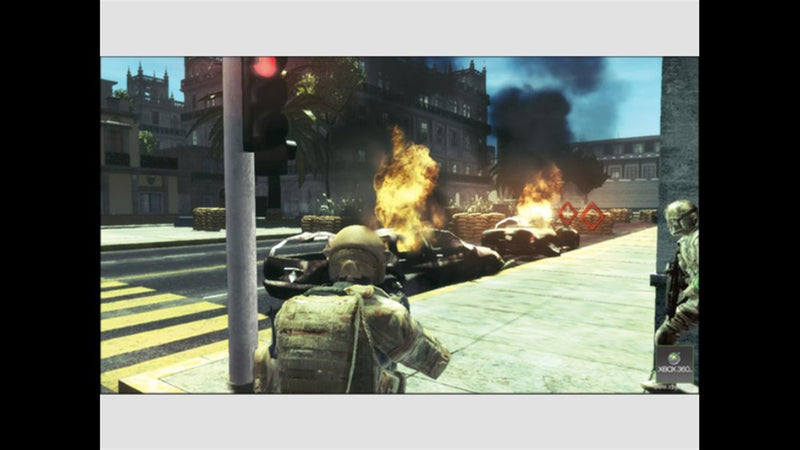 Assaut près de voitures en flammes dans Tom Clancy's Ghost Recon: Advanced Warfighter sur Xbox 360