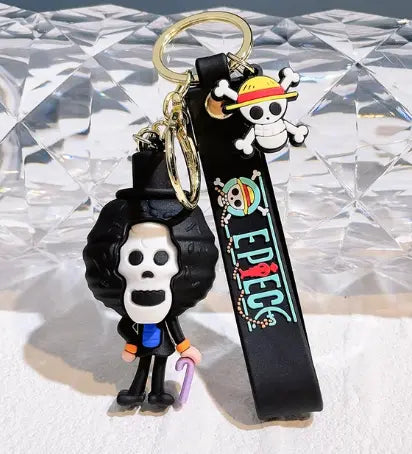Porte-clés One Piece Brook : crâne aux cheveux frisés, chapeau de paille en caoutchouc noir